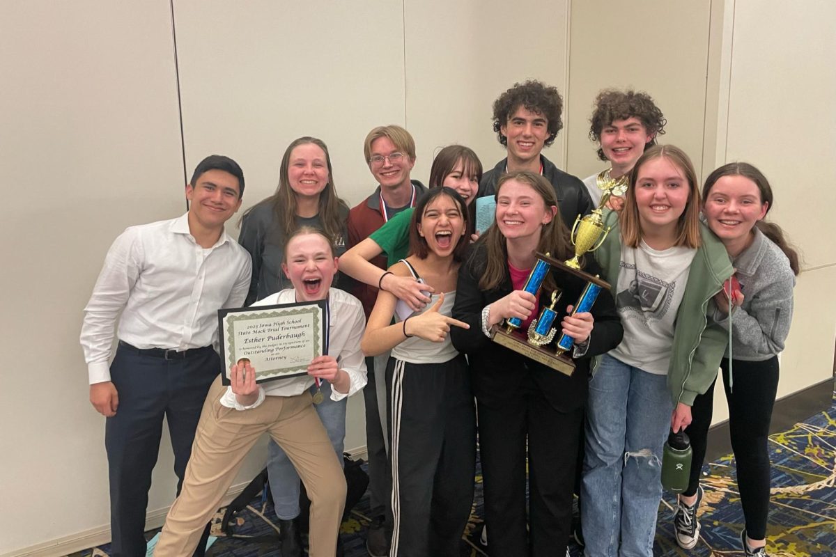 Members of the current junior team Juan Rosado, Esther Puderbaugh, Yomi Hemley, Molly Savage, Liv Leman, Olivia Vande Berg, Rachel Matel, Leo Partridge, Sadie Bodzin, Brody Clarke, and Ethan Lalumiere ‘25 pose with their trophy last year at the state Mock Trial competition. Photo courtesy of City High Mock Trial