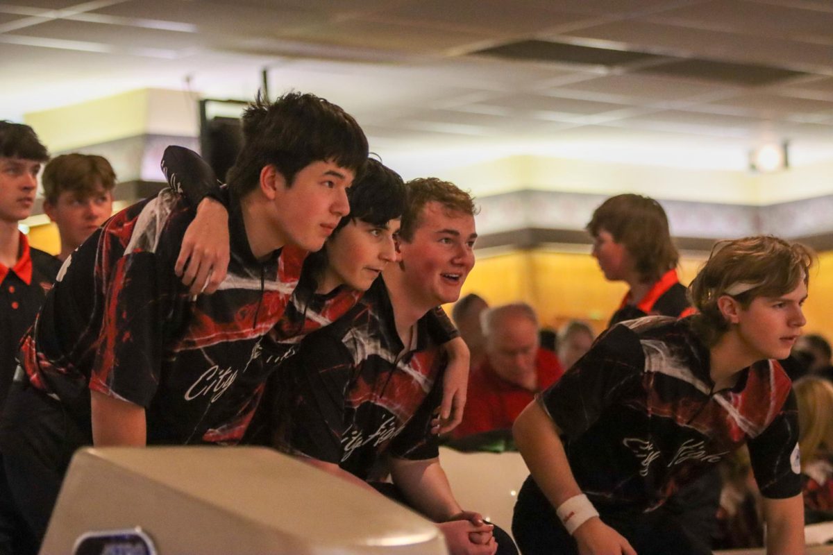 Varsity Bowlers cheering on their teammate who was about to throw a 3rd strike in a row on the 10th frame