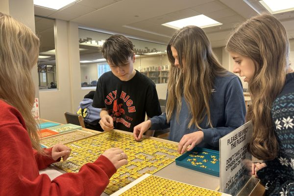 Students work on a puzzle in the Creation Station together