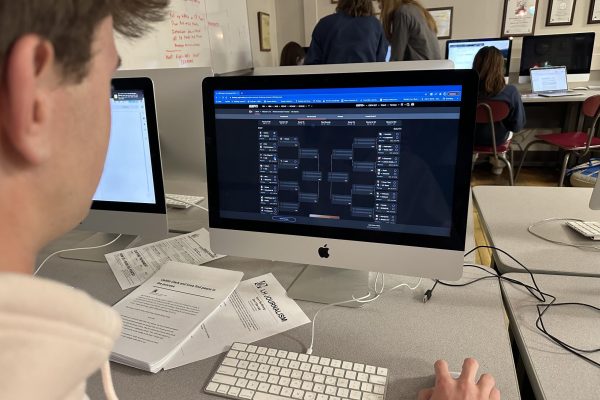 Charlie Firmstone ‘25 fills out one of his many March Madness brackets