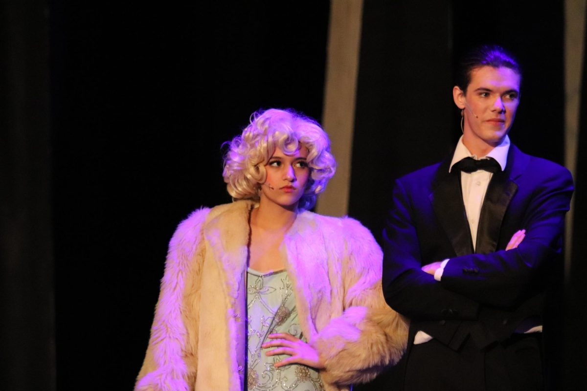 Yomi Hemley ‘25 and Ian Deleeuw ‘24 perform as Lina Lamont and Don Lockwood in ‘Singin’ in the Rain’