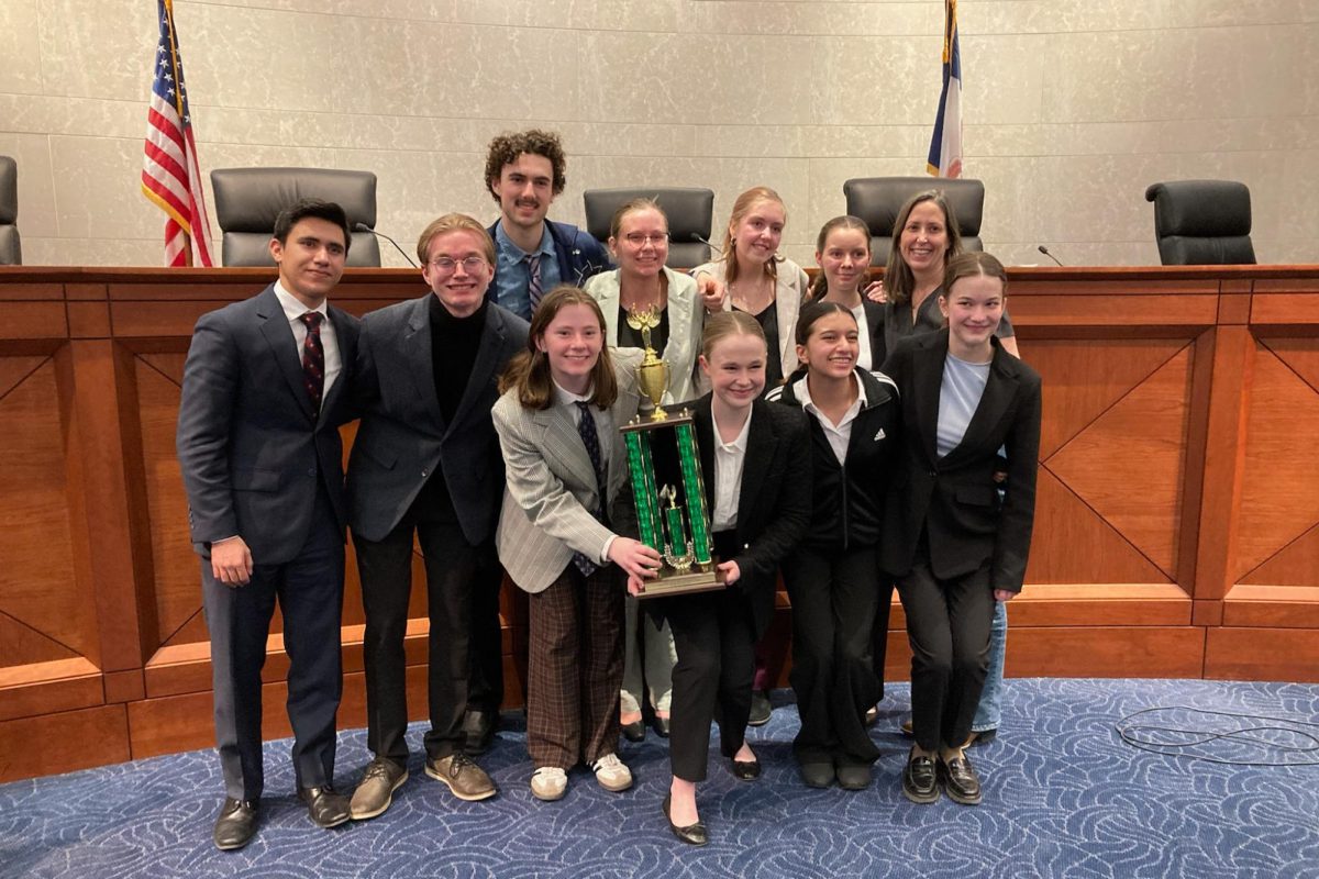 The+Junior+Team+poses+with+their+second+place+trophy+in+the+Iowa+Supreme+Court+Chambers.+Photo+courtesy+of+Liz+Matel