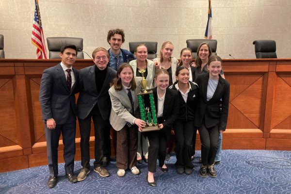 The Junior Team poses with their second place trophy in the Iowa Supreme Court Chambers. Photo courtesy of Liz Matel