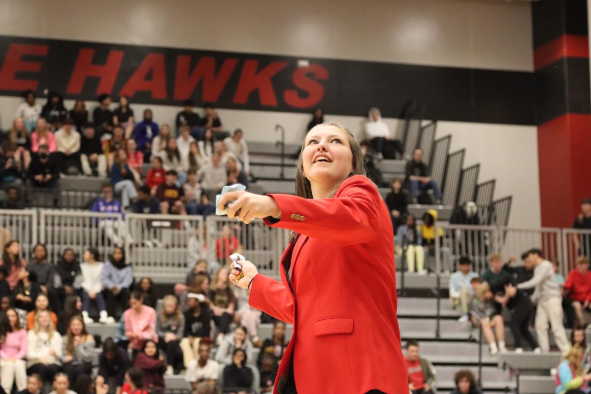 Kendra Schwarting 24 throws candy at the crowd while wearing a City High Ambassador Coat