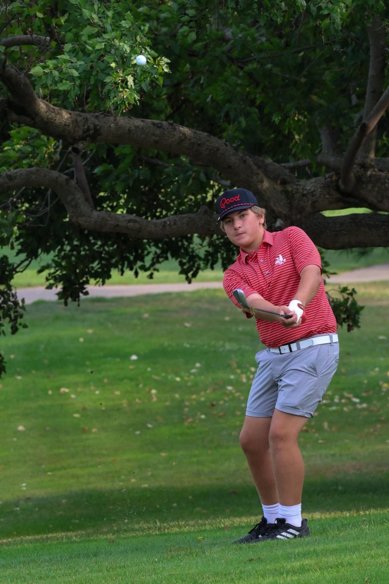 Walker Birt hits his chip shot on the 6th hole at Pleasant Valley Golf Course. He ended up with a two foot tap in par.