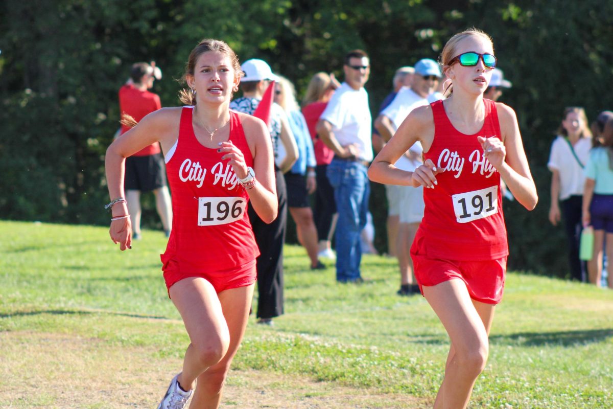 Ella Romero '27 and Maeve Nordlund '29 run to the finish line, finishing sixth and eighth respectively. 