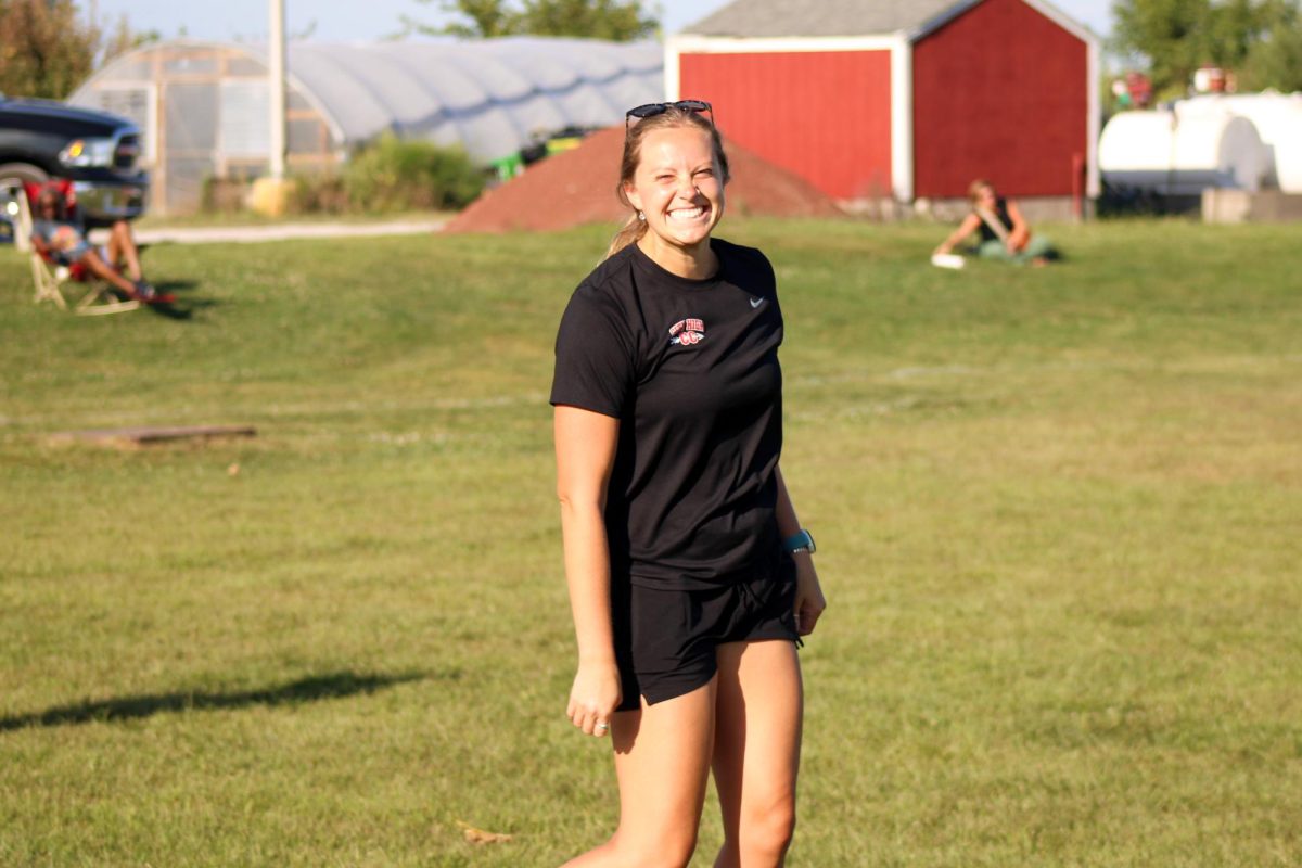 Coach Katie Rygh smiles for the camera during the meet.