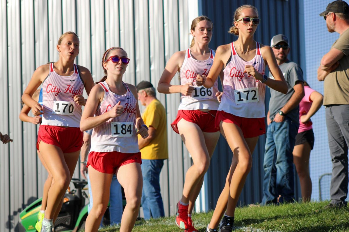 Varsity runners Madeline Fischer '27, Claire Locher '26, Naomi Downing-Sherer '27 and Calissa Fruin '28 run together as a pack. They each earned a medal by finishing in the top 20.
