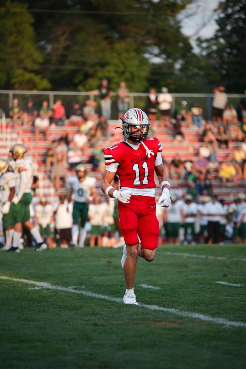 Blaine Heick '26 jogs off the field during the annual City High's "Battle of the Boot" game vs. West High. 