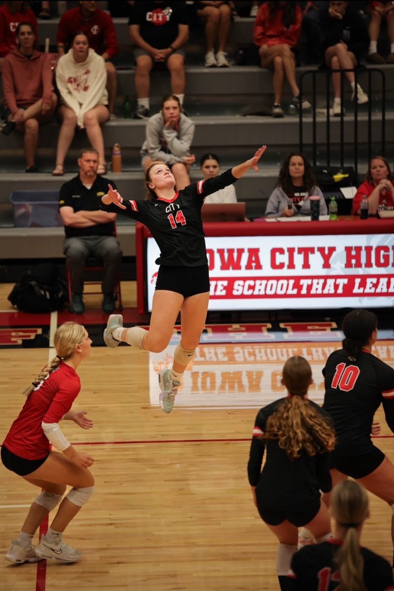 Kaitlin Loria '27 spikes the ball against rival West High