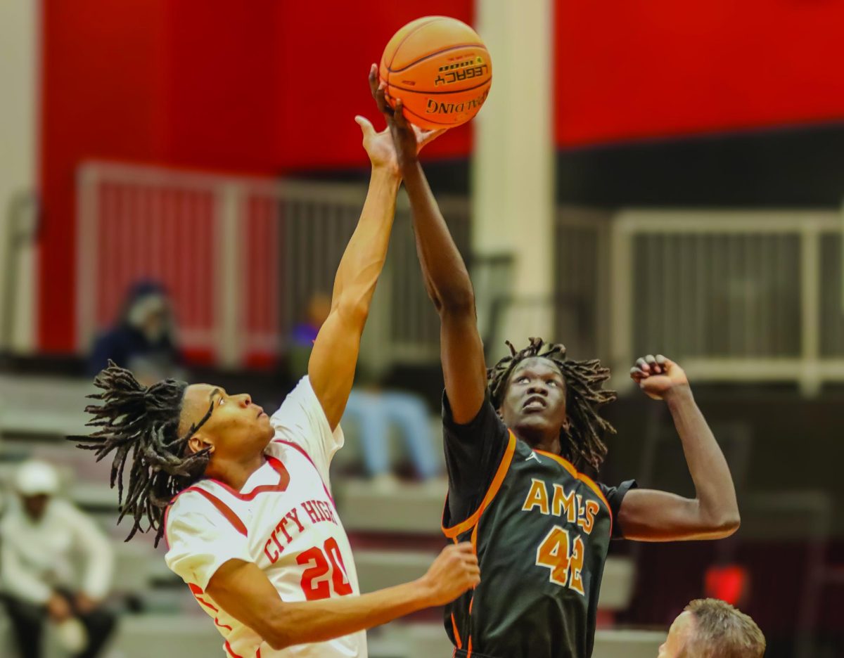 Chris Watkins '26 jumps for the opening tip off in their second game of the season last year. The team will face off against Ames in the first game of the year on December 2nd.