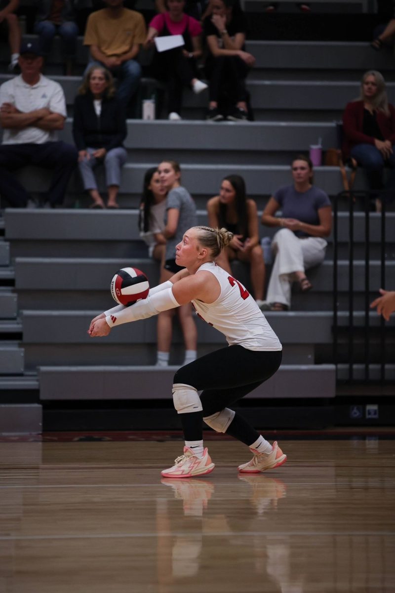 Carlson '26 returns a serve during her senior season of volleyball