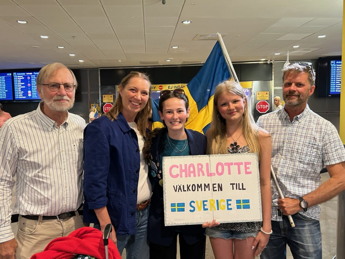 Charlotte Wills '27 with her host family upon coming to Sweden.