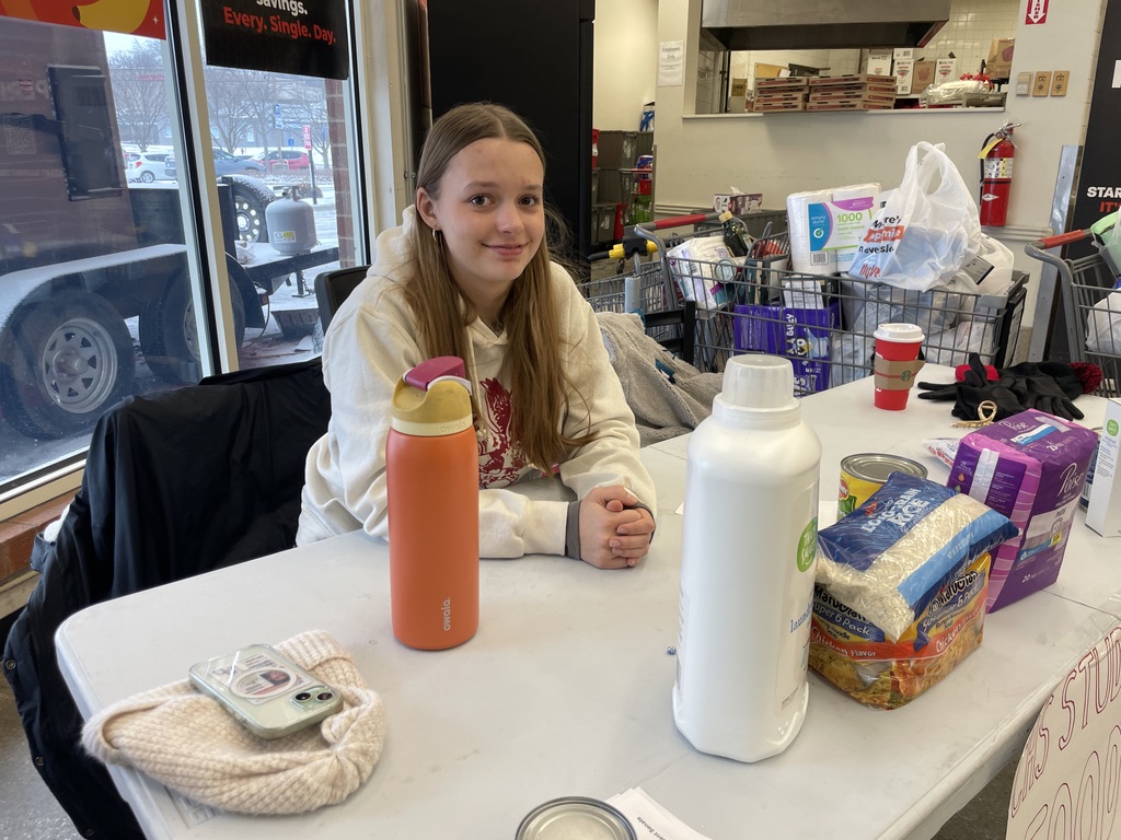 Amari Casto '27 monitors the donation table at the First Avenue Hy-Vee.
