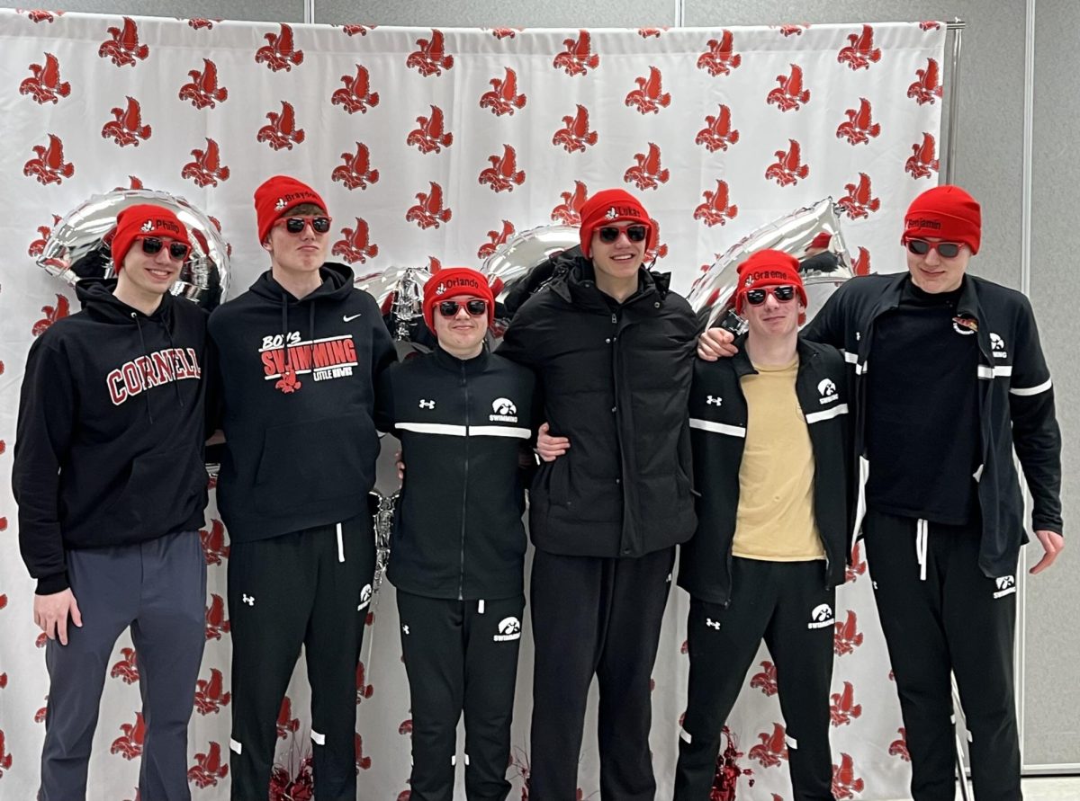 The boys swim team class of 2026 graduate line up for a picture after winning their duel meet against Jefferson.