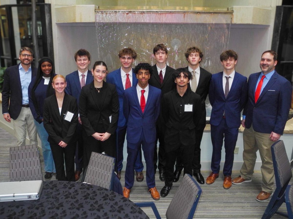 The BPA advisers, A.J. Leman and Joe Wilcox stand on the edges of the B.P.A. club.  Ramy Makawi, the president of the club led the club to the state conference for the first time in three years.