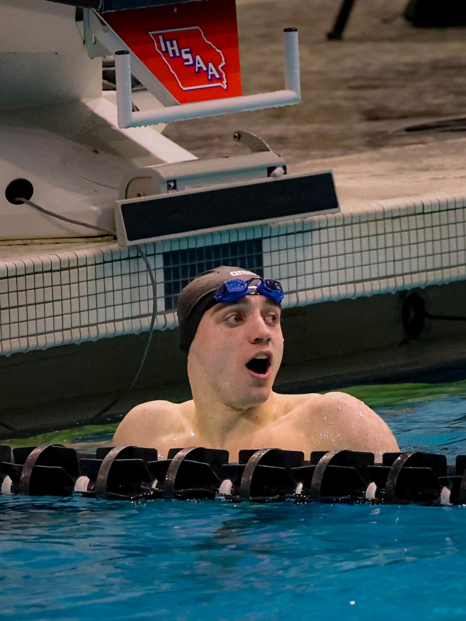 Senior Philip Berry-Stoelzle stares at his personal record time in shock. Philip places 4th in the 100 and 200 freestyle at the state swim meet. He also swam on the 200 and 400 freestyle relays at state.