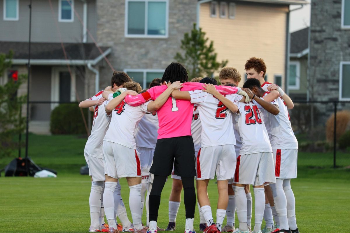 City High boys soccer team does their pre-game huddle before their matchup against Liberty High School. The Little Hawks went on to win  the game with a score of 3-1. 
