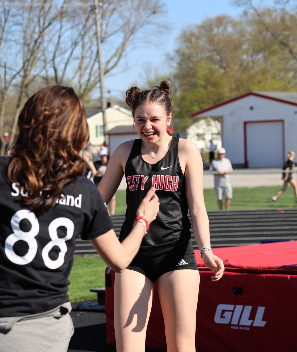 Going in for a high five, Alice Edelen '27 celebrates moving to the next height with her coach. "When I do reach new achievements it feels really good because [my coach is] always really proud of me," Edelen said.