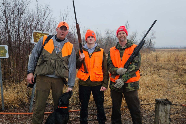 Ben Klitgaard '26 (middle) goes pheasant hunting with his cousin Mark (left), his uncle Devin (right), and Mark's dog, Remi. Photo courtesy of Ben Klitgaard.