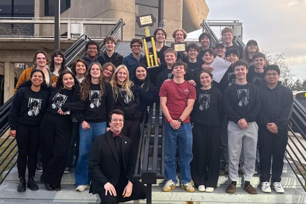 Jazz Ensemble poses for a photo with their trophy after awards are announced.